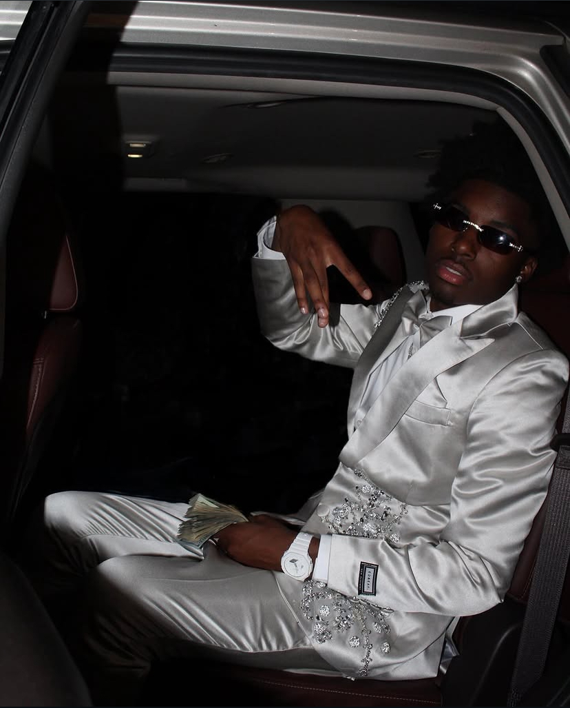 TLC Photography formal portrait of client wearing a white suit in a car